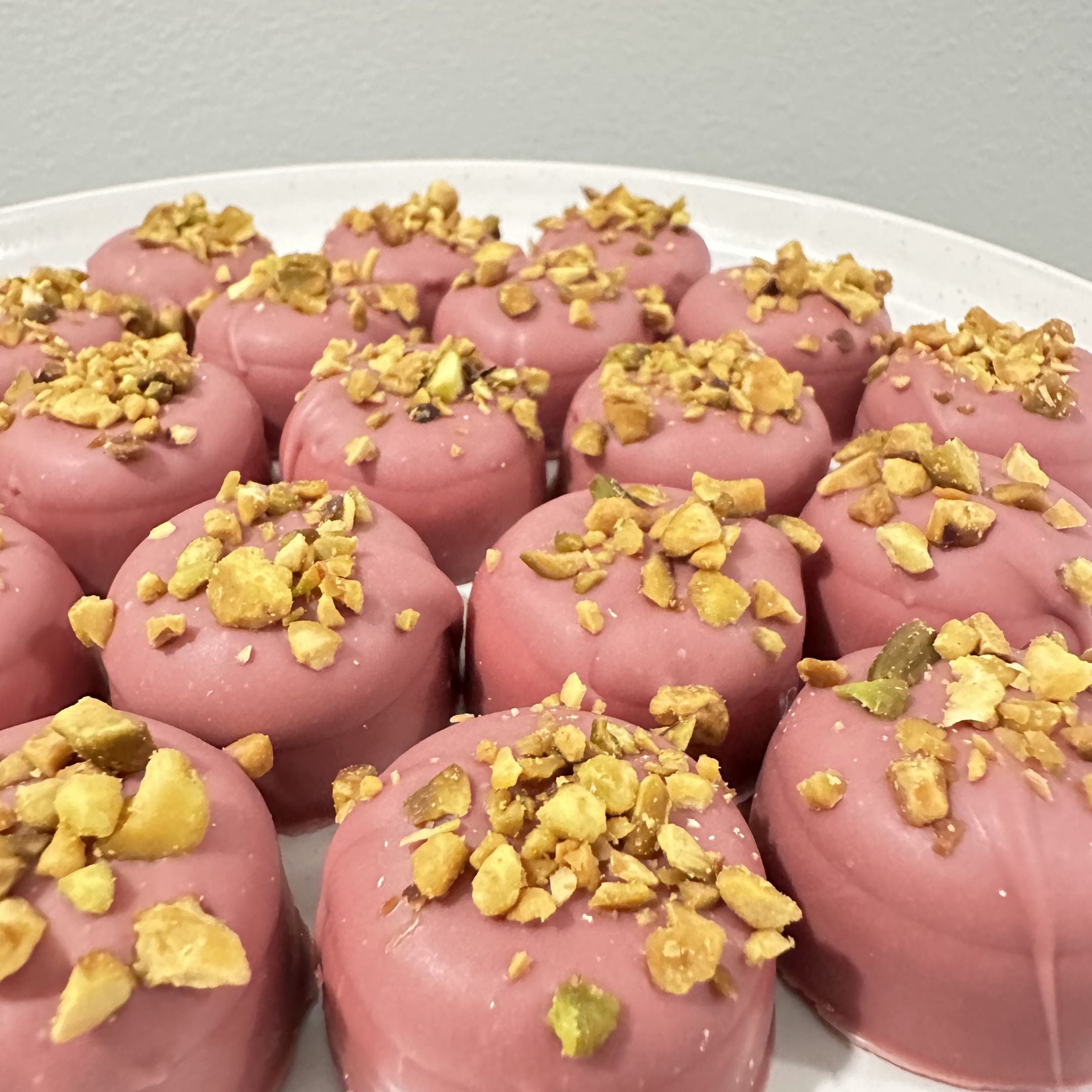 Chocolate On Purpose Ruby Pistachio Truffles with layers of Pashmak (persian ferry floss) and creamy pistachio butter, dipped in pink ruby chocolate, and topped with roasted pistachio nuts. A delicious Valentine’s Day gift idea