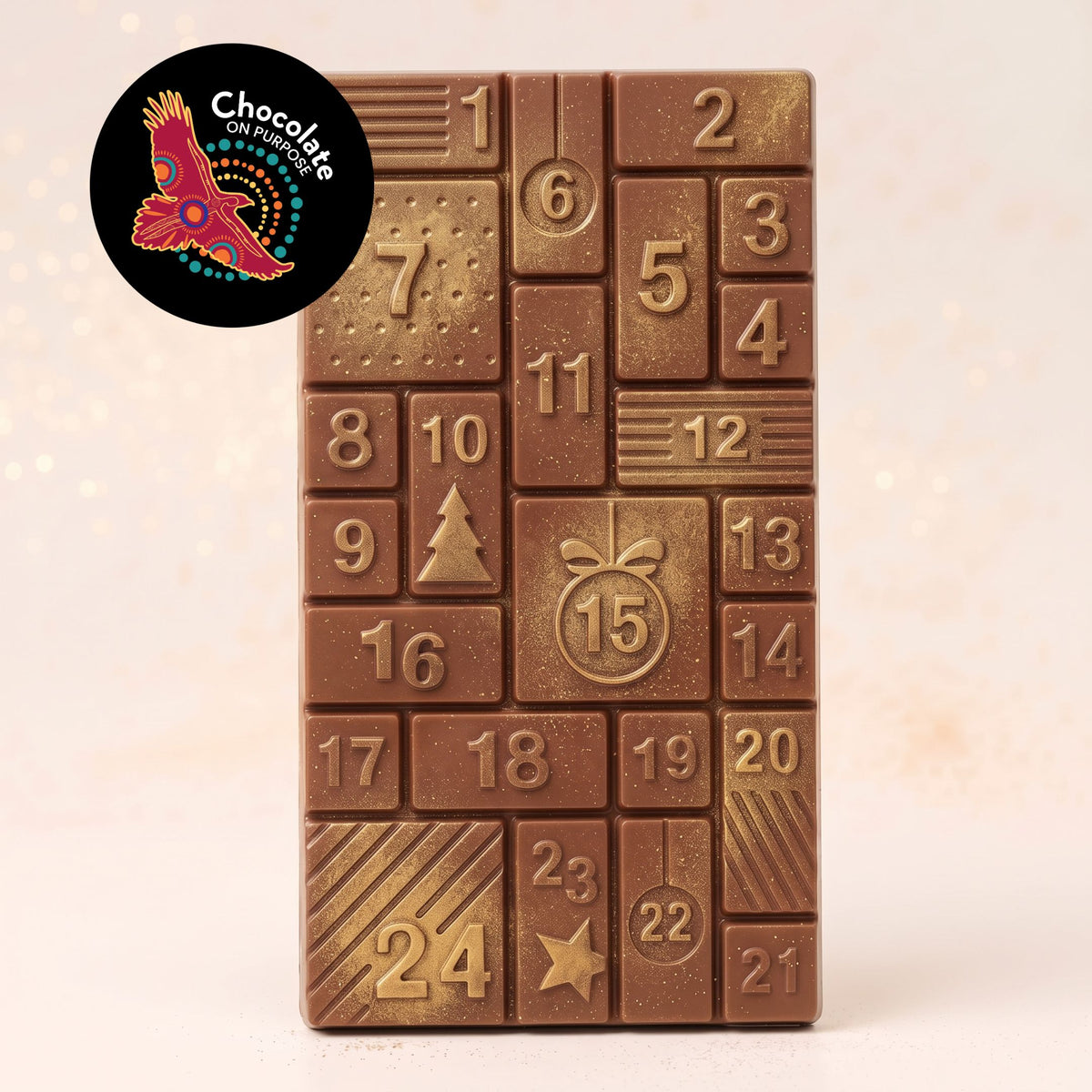 Warruyarra (to count in Wiradjuri language) milk chocolate advent calendar bar with Munthari (Muntrie Berry), 24 numbered windows with gold lustre dust. Chocolate On Purpose logo of Eagle, with Spirit within.