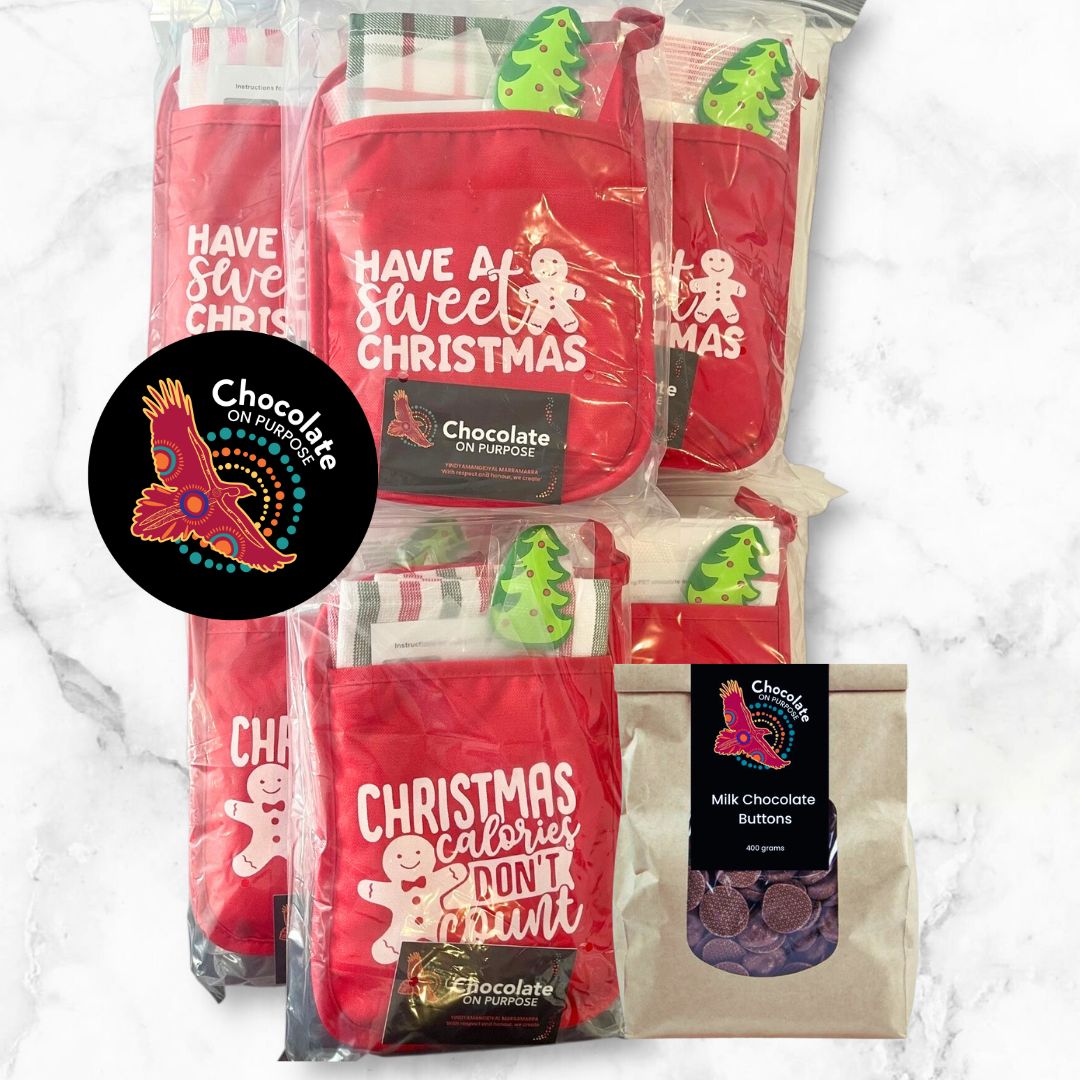 Five red Chocolate On Purpose® Christmas chocolate making kits displayed together, each featuring white festive text (