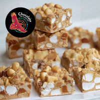 Murru Malang golden caramelised rocky road chocolate stacked in three layers showing marshmallows, peanuts, and sea salt. Chocolate On Purpose logo badge displayed. Product photography on white background.