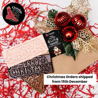 Chocolate On Purpose 'Merry Christmas Gift Hamper Bag' with three chocolate bars, White Chocolate with Ooray (Davidson Plum) and Milk Chocolate with Munthari (Muntrie Berry) and Dark Chocolate with Gulalung (Finger Lime), bag decorated with embellishment of red baubles & gold holly leaves with Babiin Ngungghi (Father of Giving) Gift Tag and Chocolate On Purpose Logo stamp. With message that Christmas Orders shipped from 15th December.

