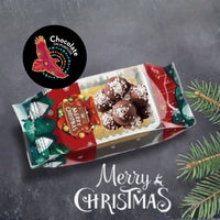 Christmas Rum Balls gift packaging featuring festive red and green design with Chocolate On Purpose logo, handcrafted dark chocolate rum balls topped with coconut, displayed in branded box with "Merry Christmas" greeting
