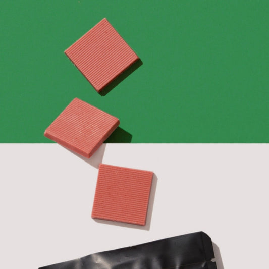3 pieces of Pink Raspberry chocolate on green and white background